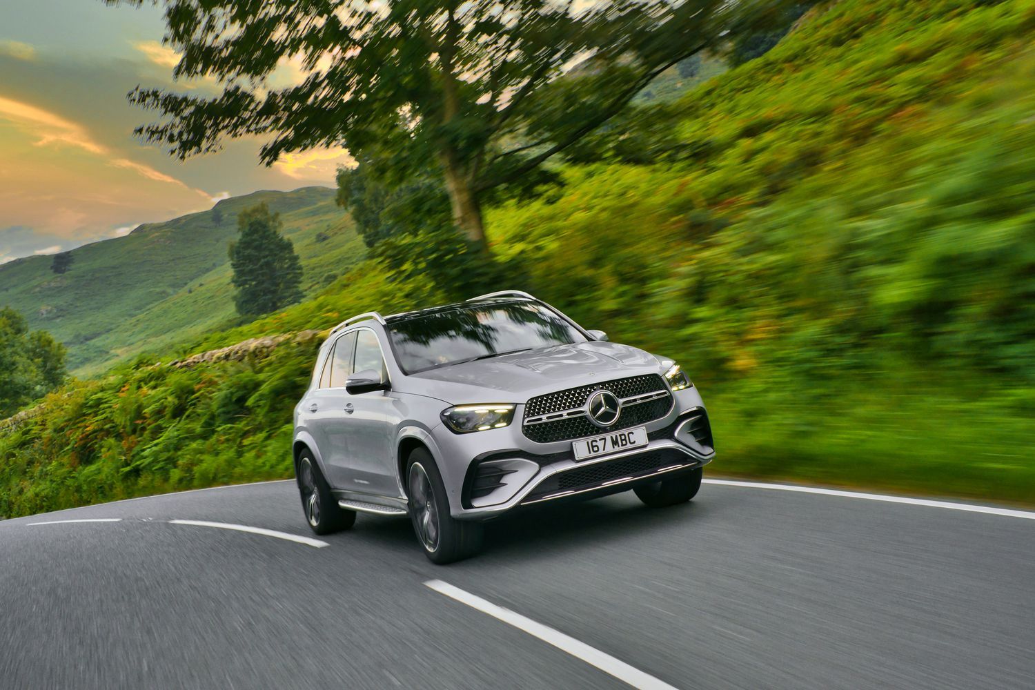 Front view of a silver Mercedes-Benz GLE driving.
