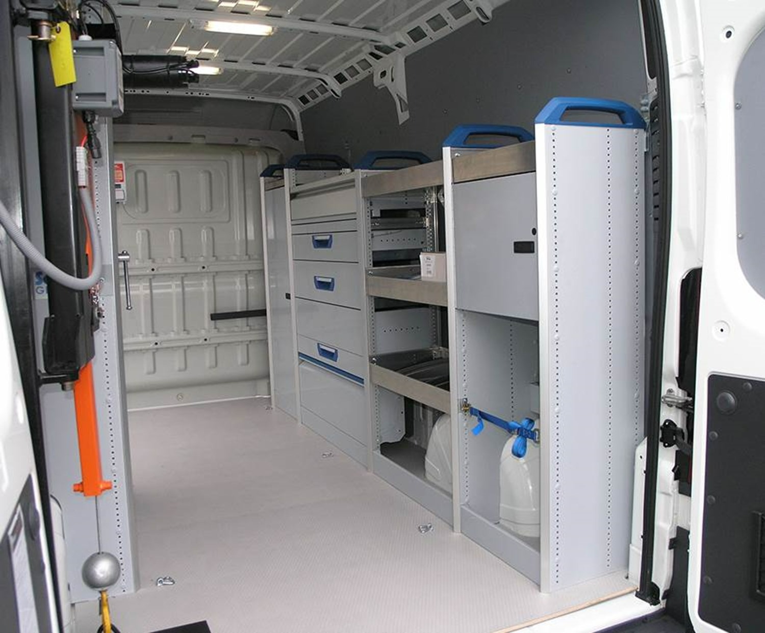 Van load area fitted with racking, drawers and storage compartments for tools.