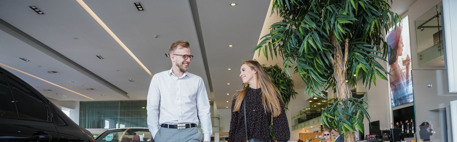 BMW Customer chats to team member about the BMW Used Car Programme inside of the Bavarian BMW showroom