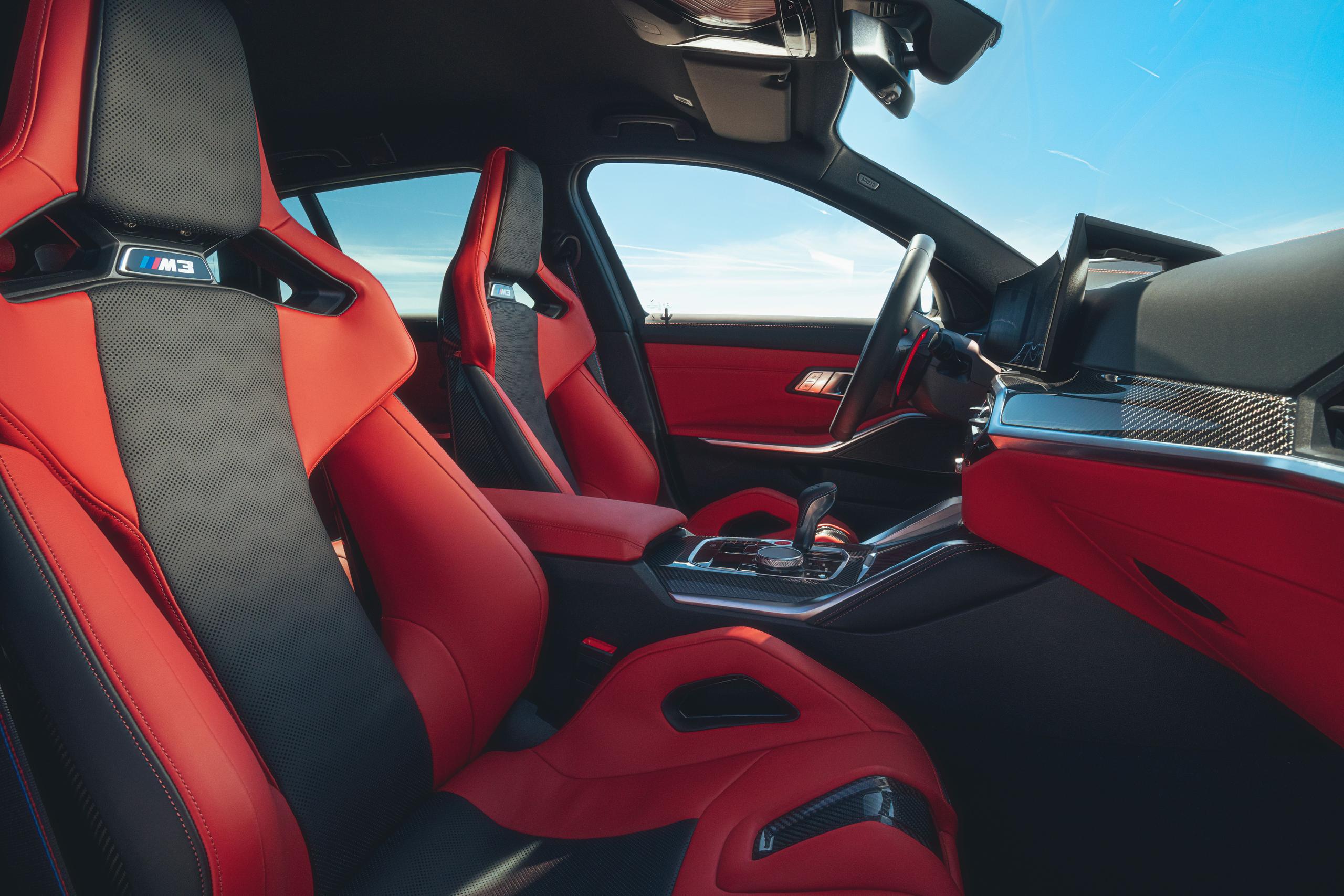 New BMW M3 Competition Touring red and black bucket seats