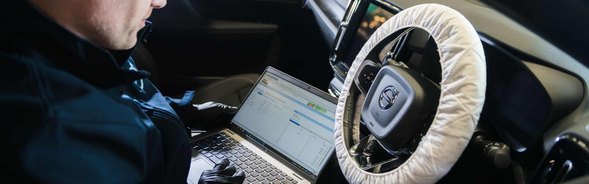 Agnew Belfast Volvo repair specialist inspects car on laptop during Volvo Healthcheck.
