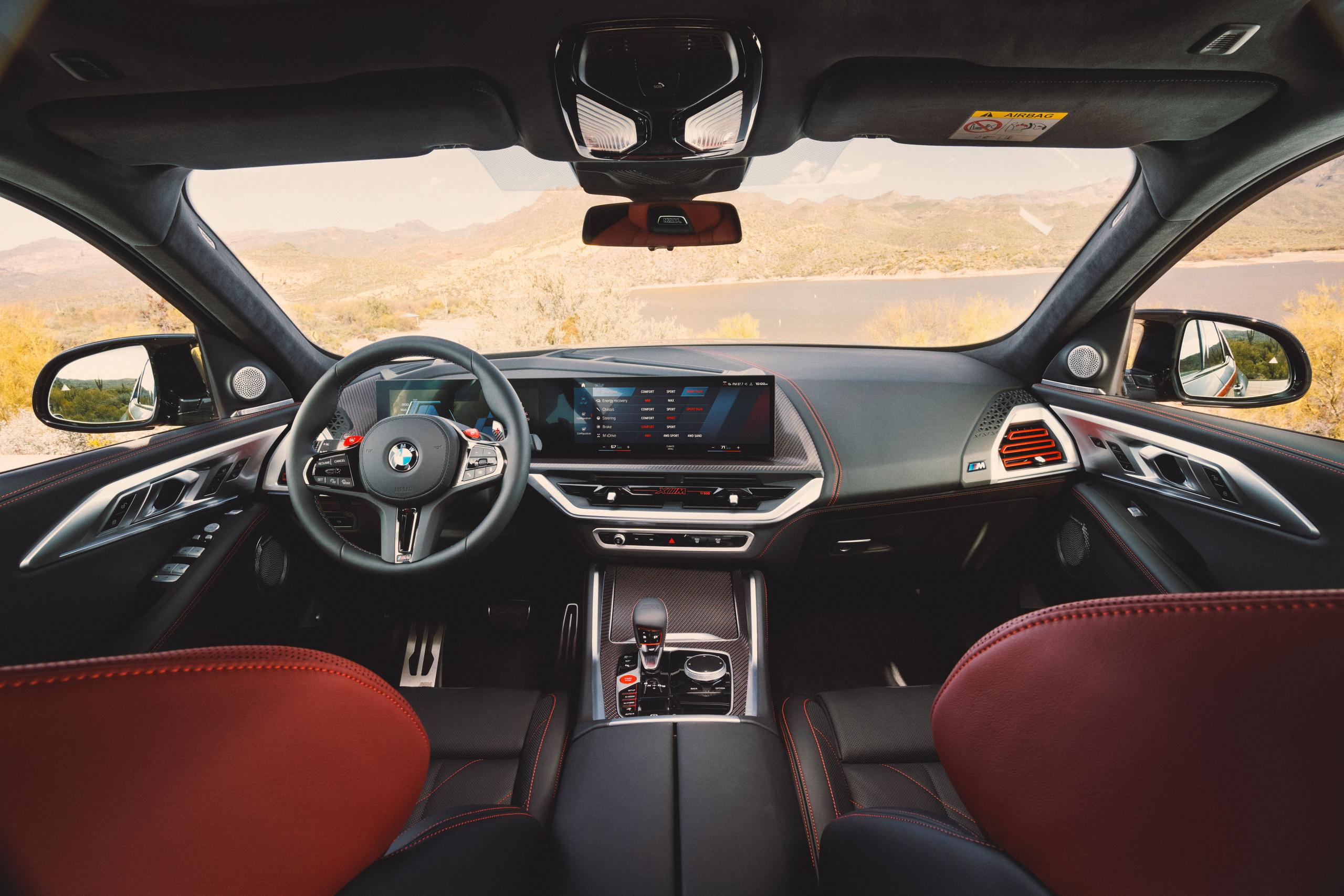 New BMW XM front interior view of steering wheel and infotainment system