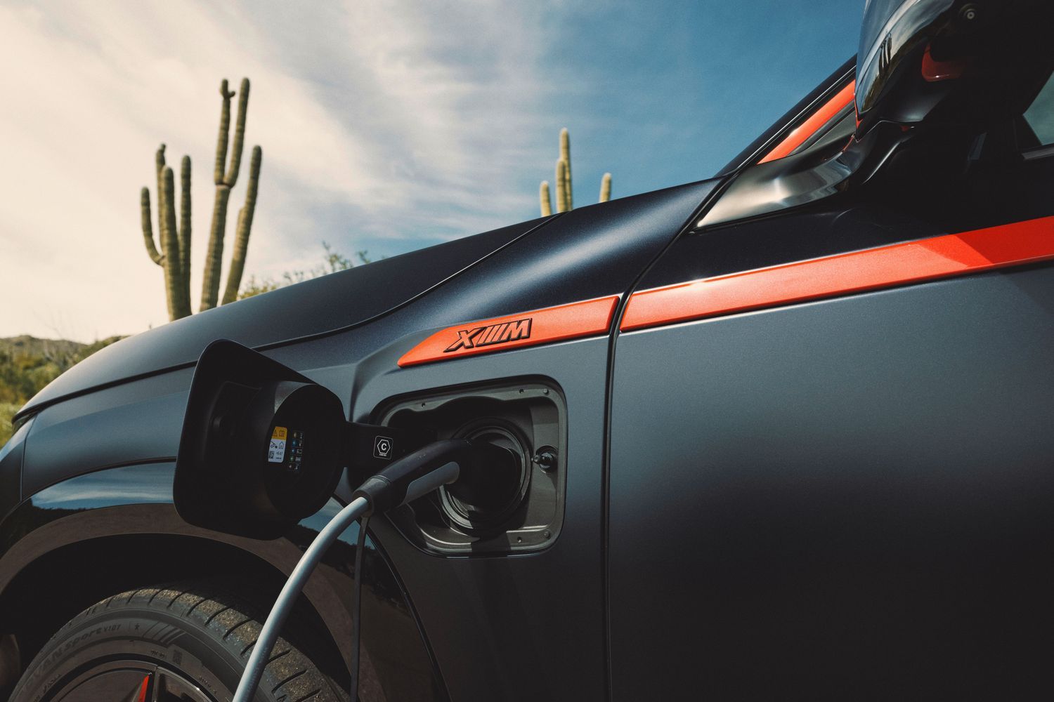 New BMW XM image of vehicle being charged by electric