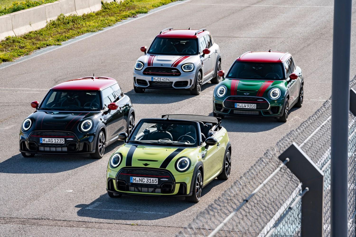 The new MINI John Cooper Works range in different colours, at the starting line of a racetrack