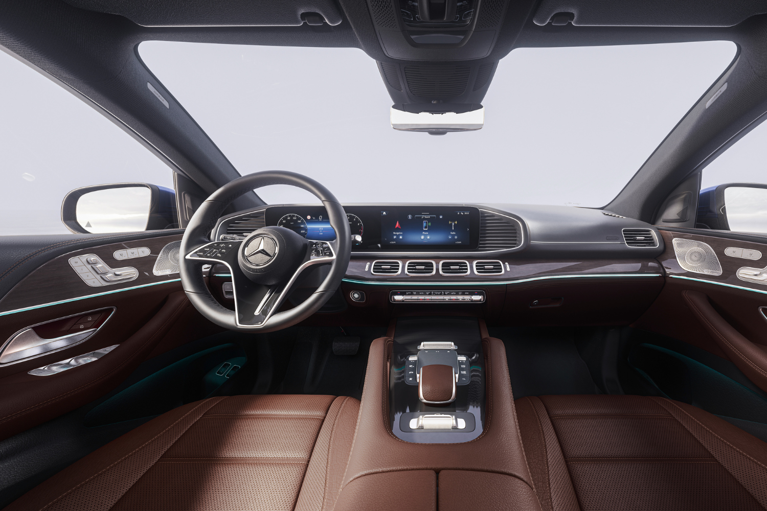 Tan interior seats, black steering wheel and widescreen driver display inside a Mercedes-Benz GLE Coupé.