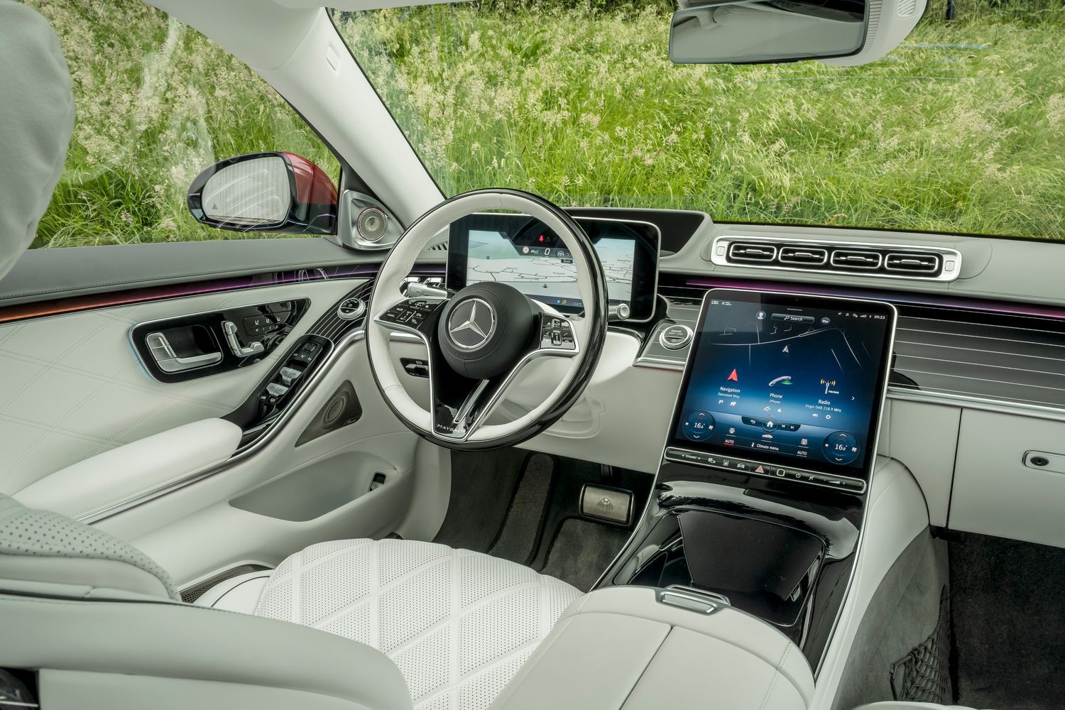 Mercedes-Maybach S-Class white interior seats with a black and white steering wheel and two driver displays.