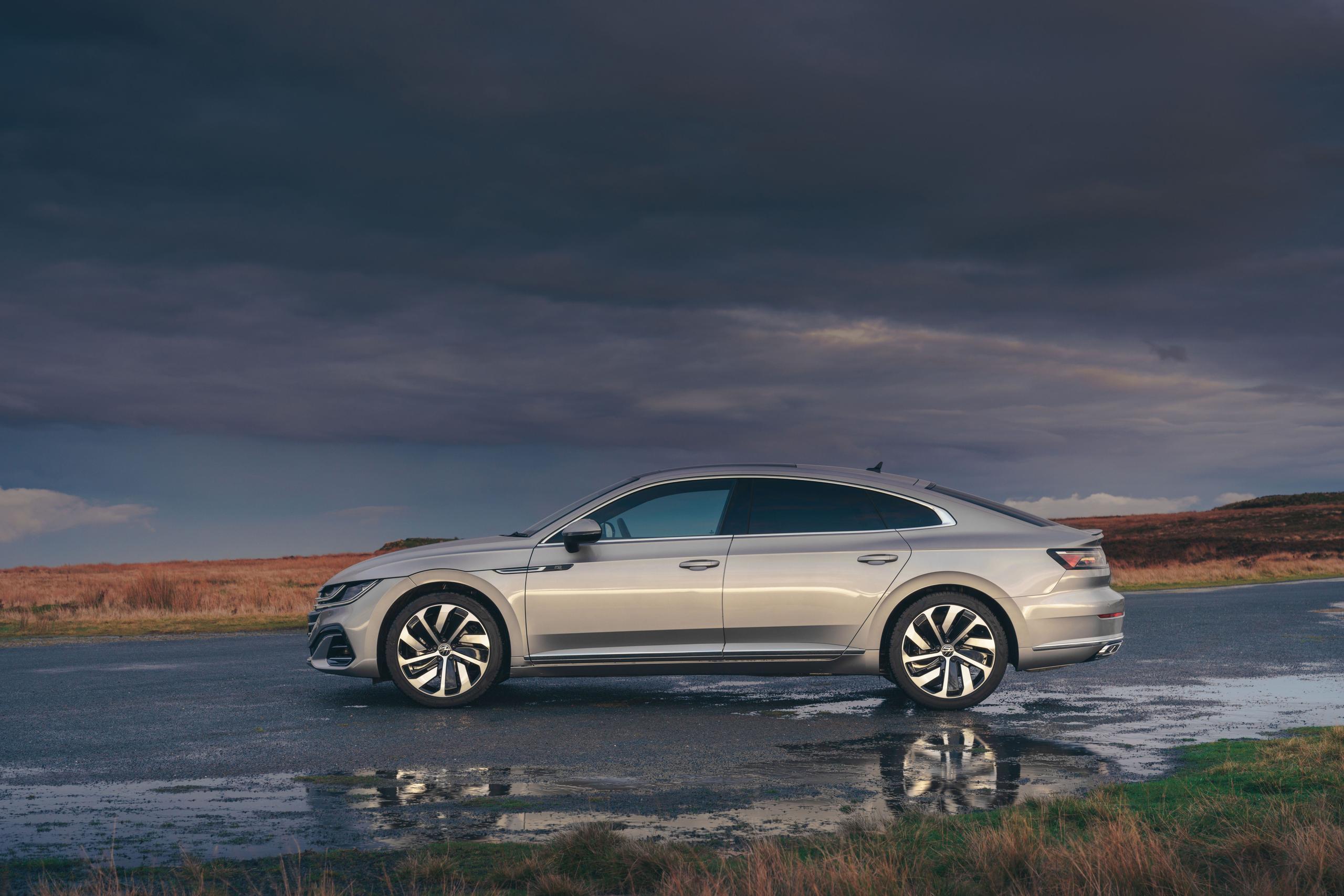 Side view of the new Volkswagen Arteon in silver, parked in a countryside car park