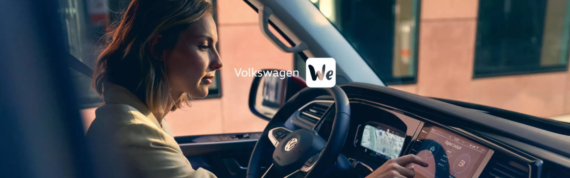 Interior view of a Volkswagen Golf with the driver selecting features on the main central console. The words 'Volkswagen We' are present on top of the image.