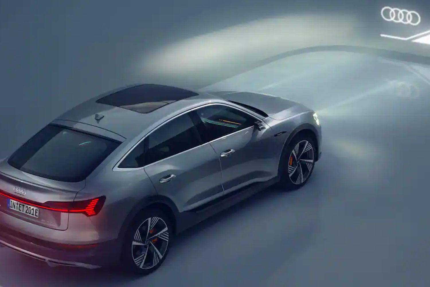 Side view of an Audi e-tron GT quattro with lights on