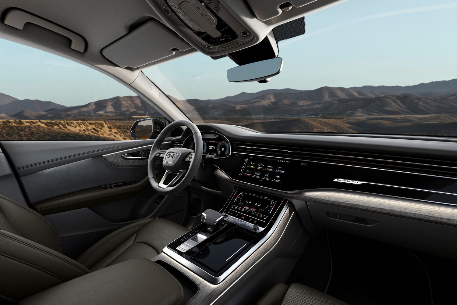 Passenger view of the Audi Q8 TFSI E black leather interior and driver display.