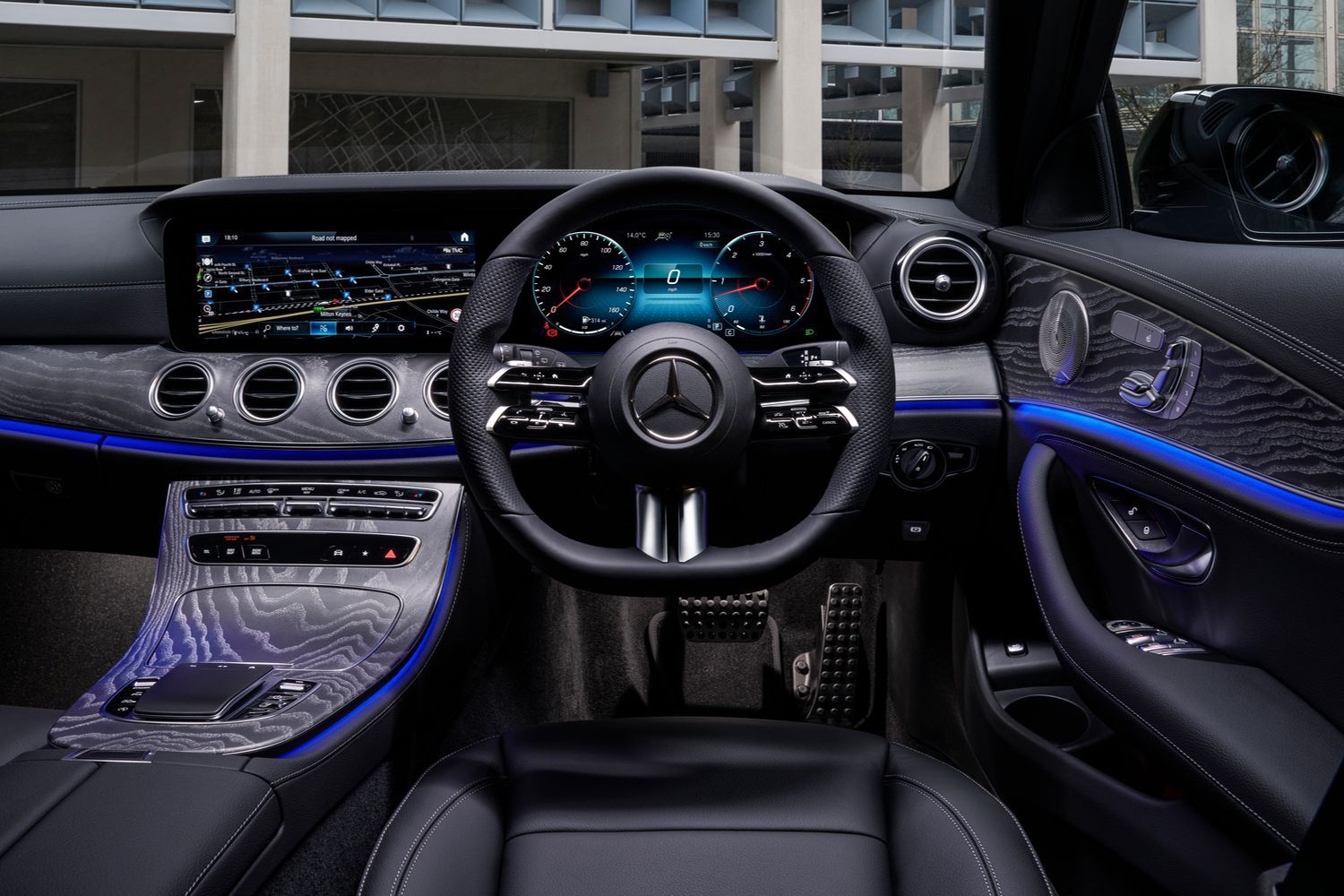 Mercedes-Benz E-Class Estate steering wheel, dual infotainment displays and blue LED light features.