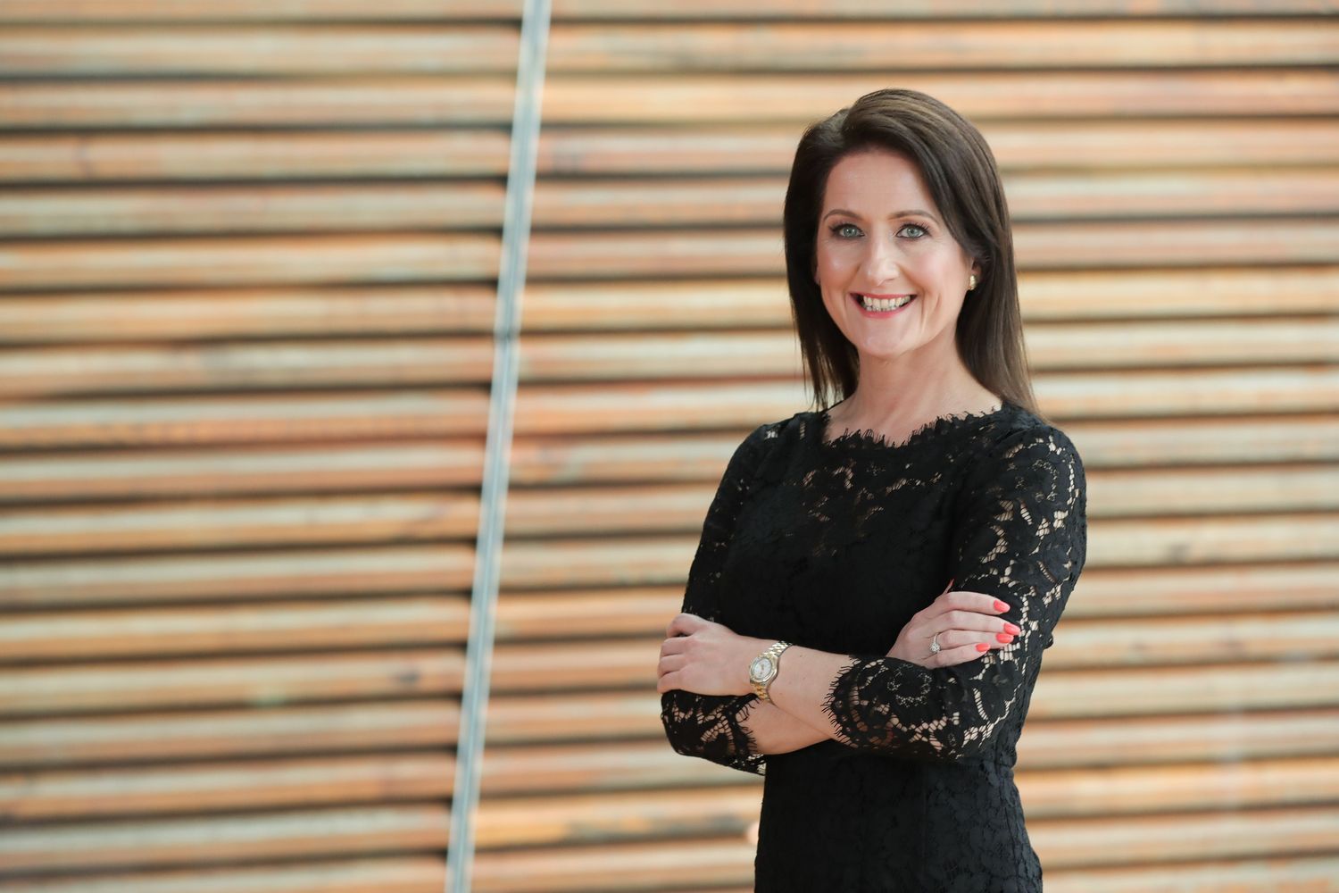 Sonya Cassidy smiles against wooden office background