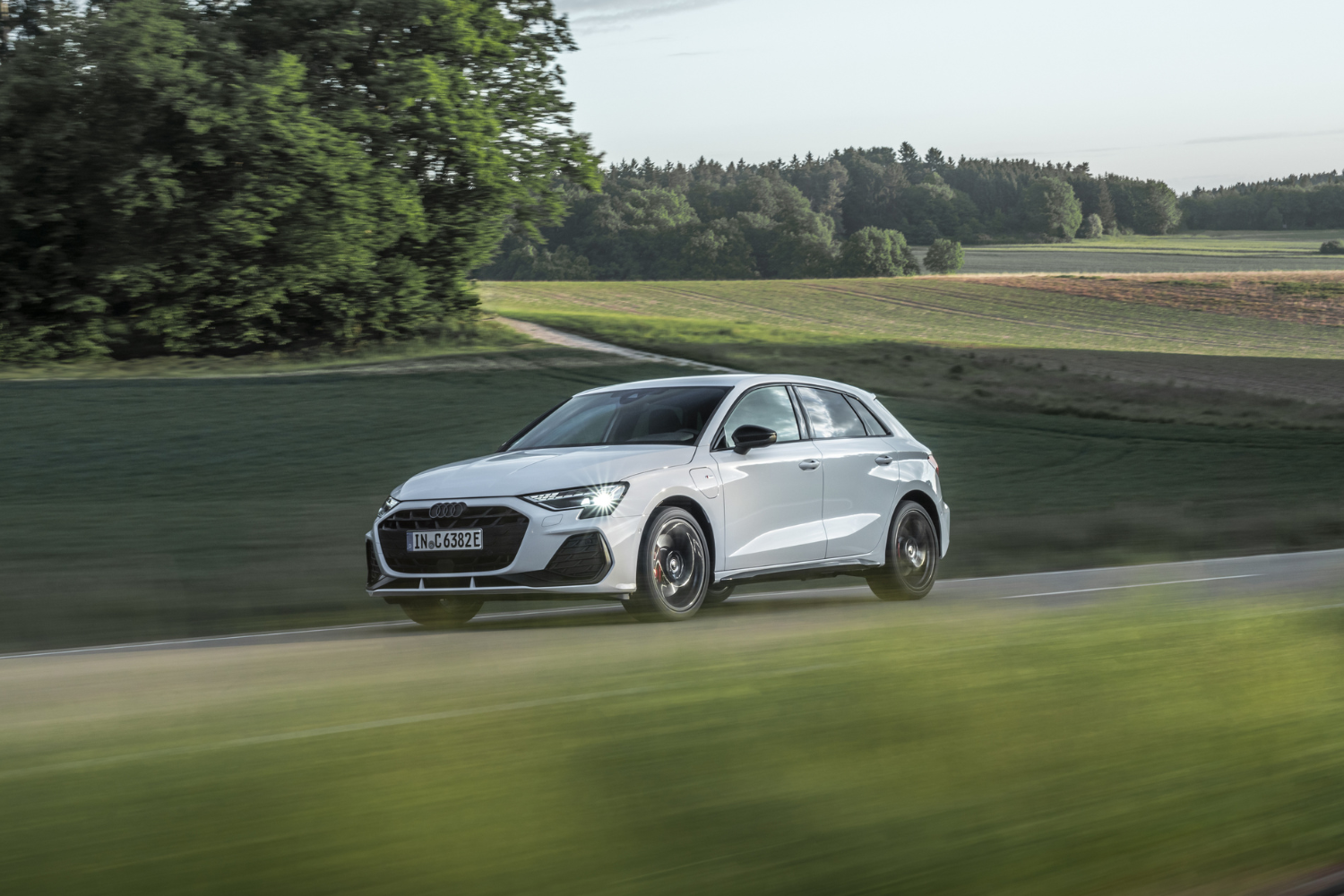 The new Audi A3 Sportback TFSI e driving fast along country roads.