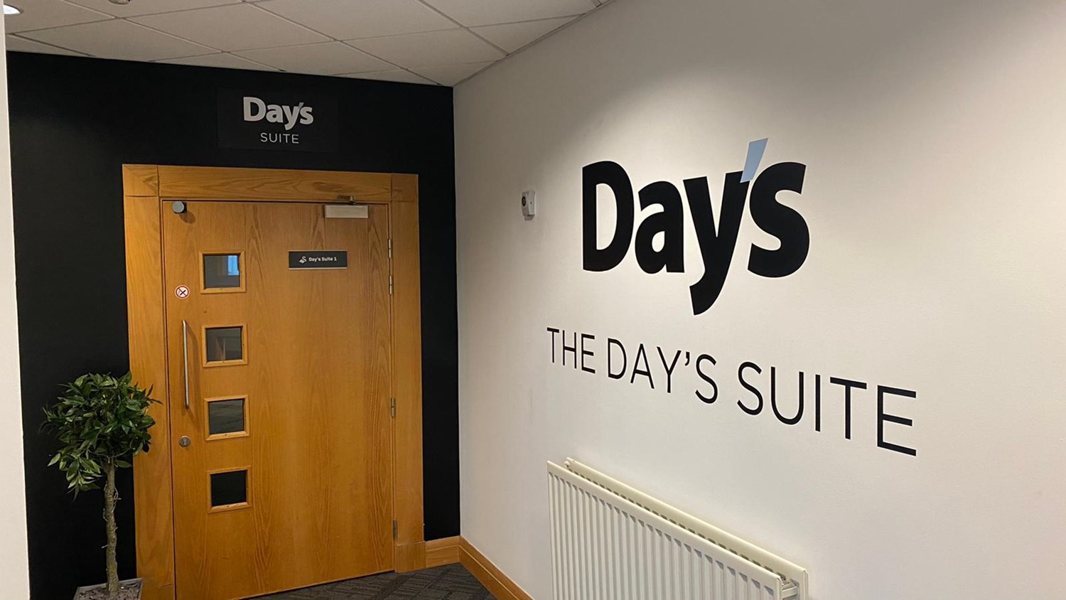 Office building door with Day's The Day's Suite written on the wall next to it