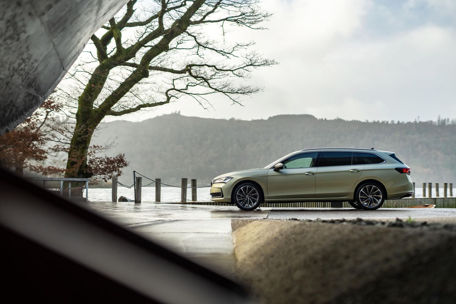 Side view of the new Skoda Superb Estate. Parked by large tree.