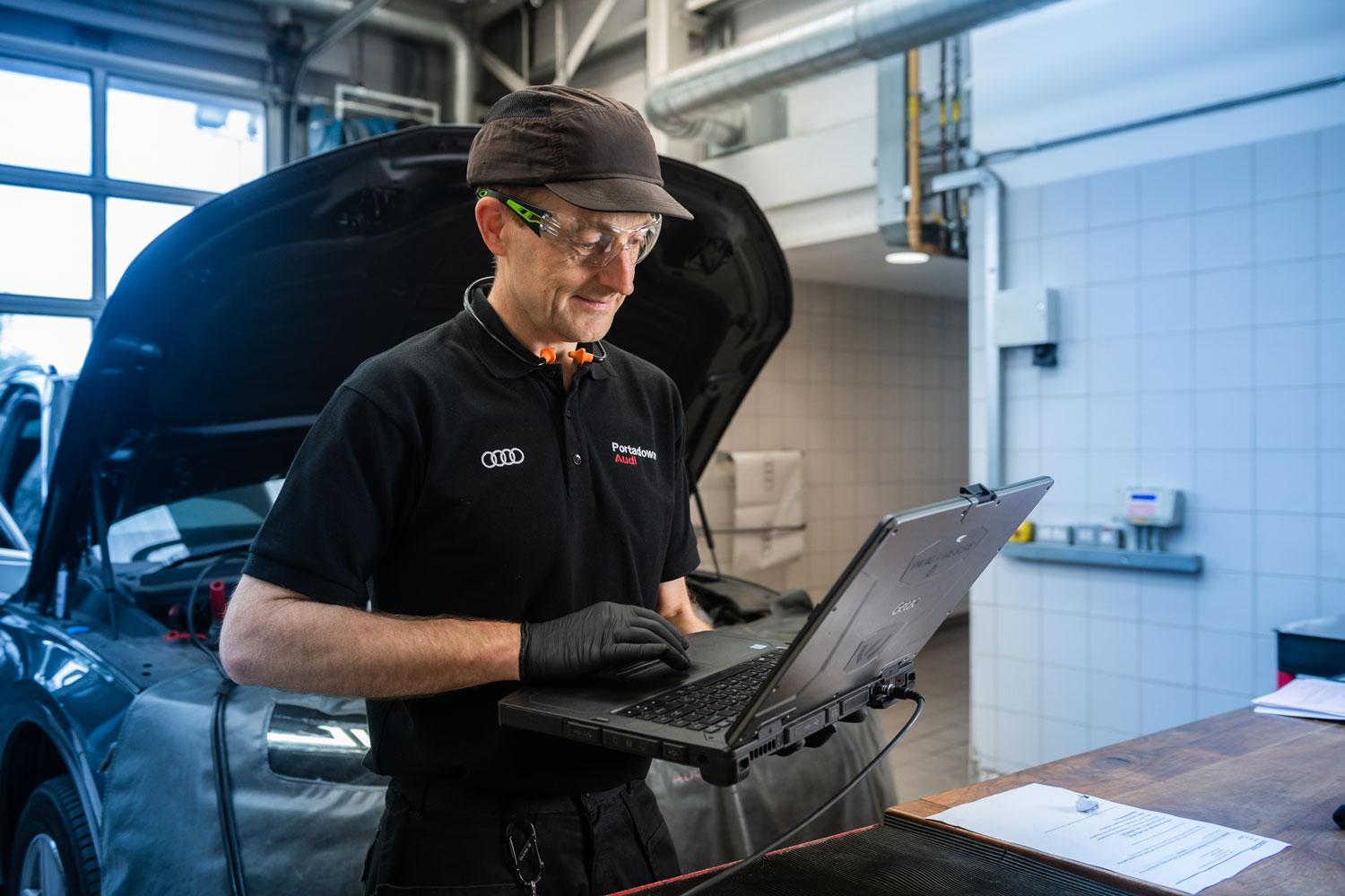 Audi repair specialist carrying our maintenance work on a used Audi