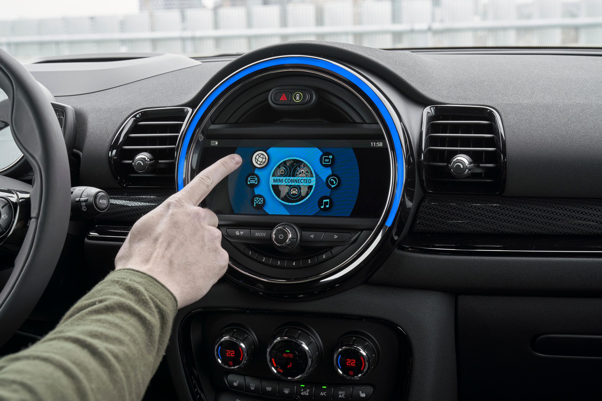 Interior view of the new MINI Clubman, close-up of central console with driver selected the world icon on the MINI Connected app