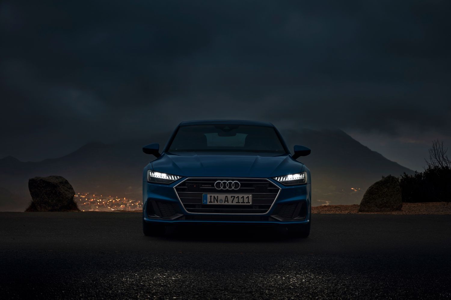 New Audi A7 Sportback in blue parked with headlight lights on