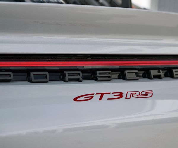 Close up of the rear end of a white Porsche RS.