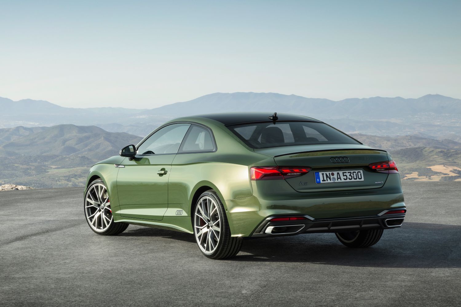Image of new Audi A5 Coupe in green from behind showing brake lights lit up and sporty alloys.