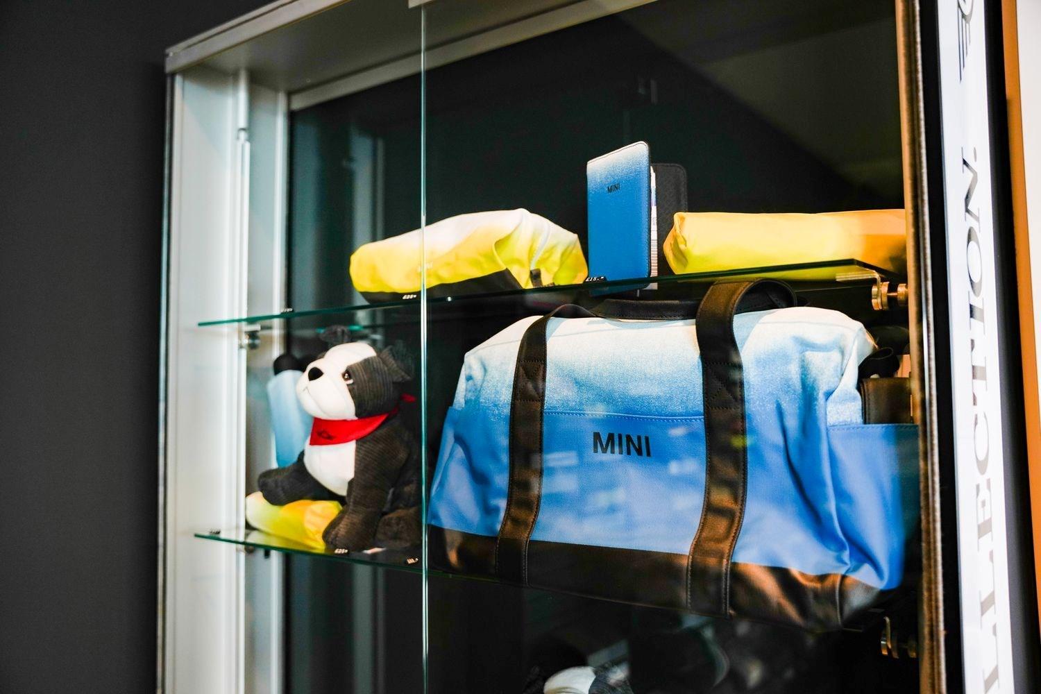 Close-up of some of the MINI Accessories & Merchandise available at Bavarian MINI. Pictured: MINI Duffle bag, MINI stationary, MINI toy dog and MINI Clothing