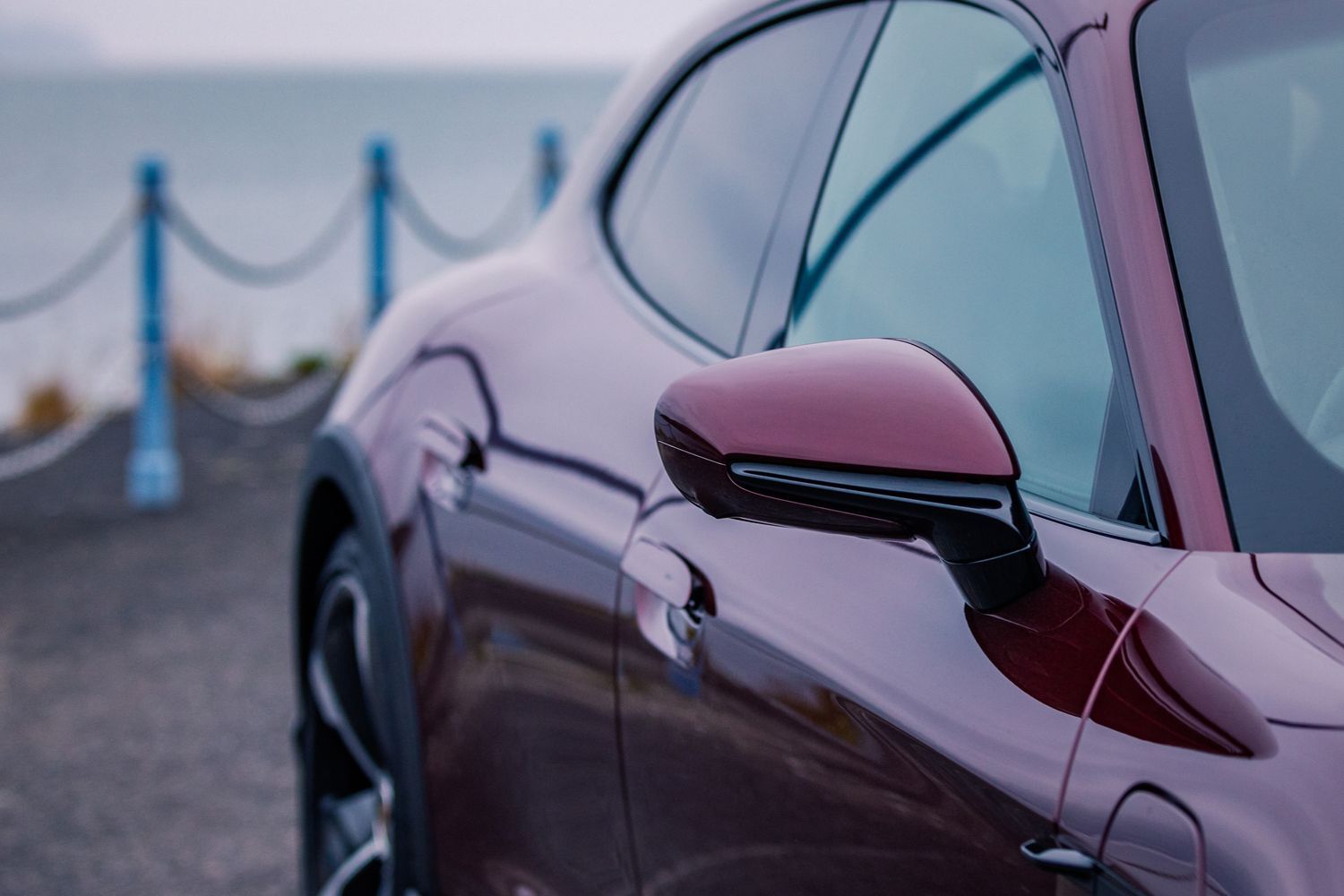 Close-up on the wing mirror of the latest Porsche 911, in purple