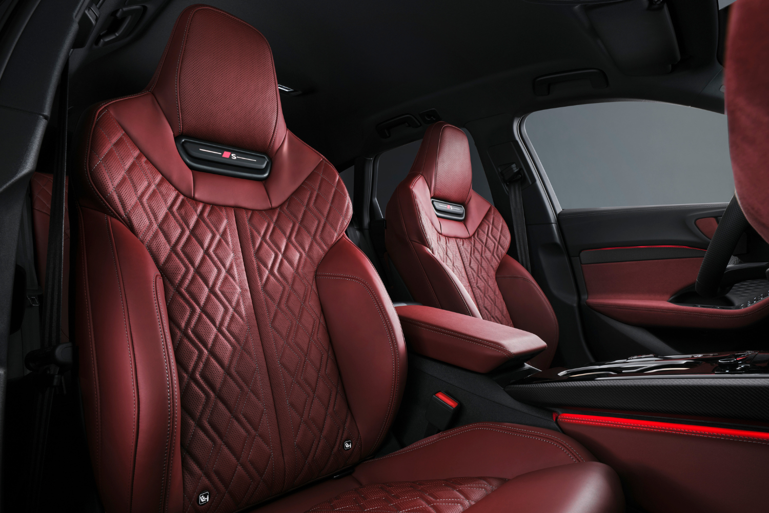 Audi S5 Avant with red leather interior seats featuring an 'S' logo and red interior lights.