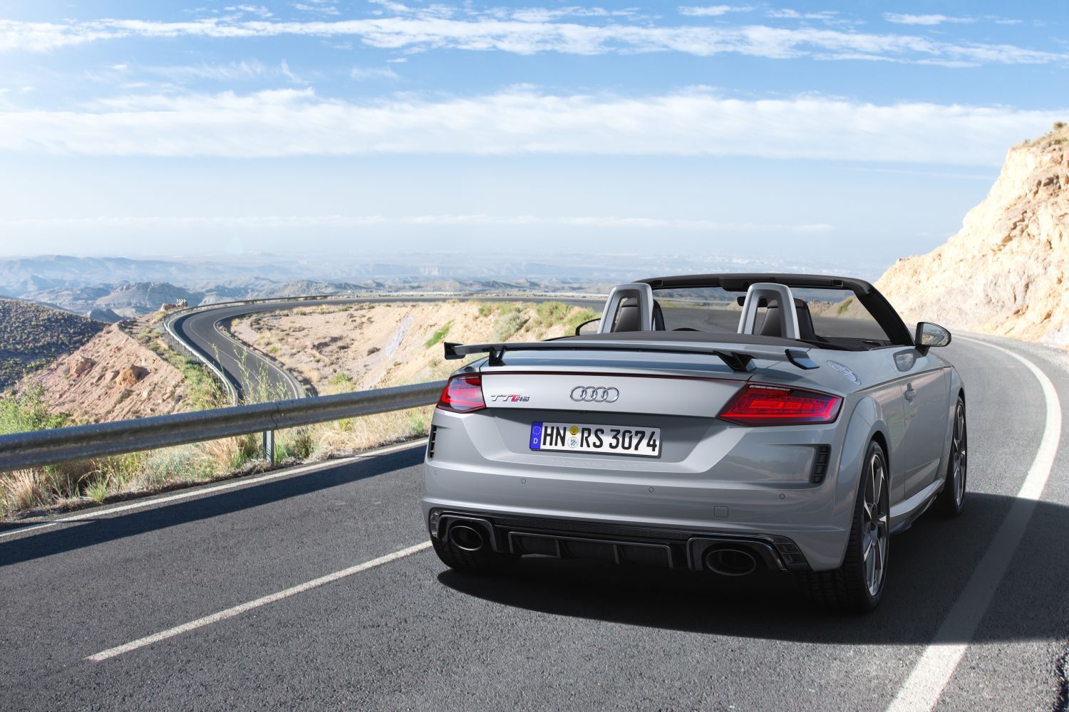 New Audi TT RS Roadster in silver, view of vehicle driving from behind