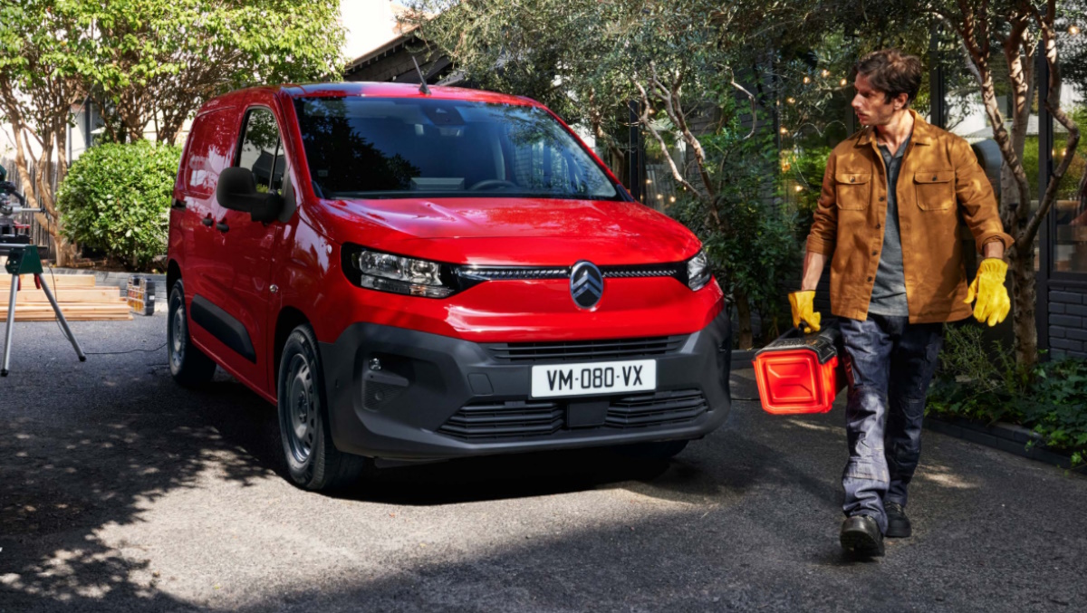 man by a red citroen berlingo