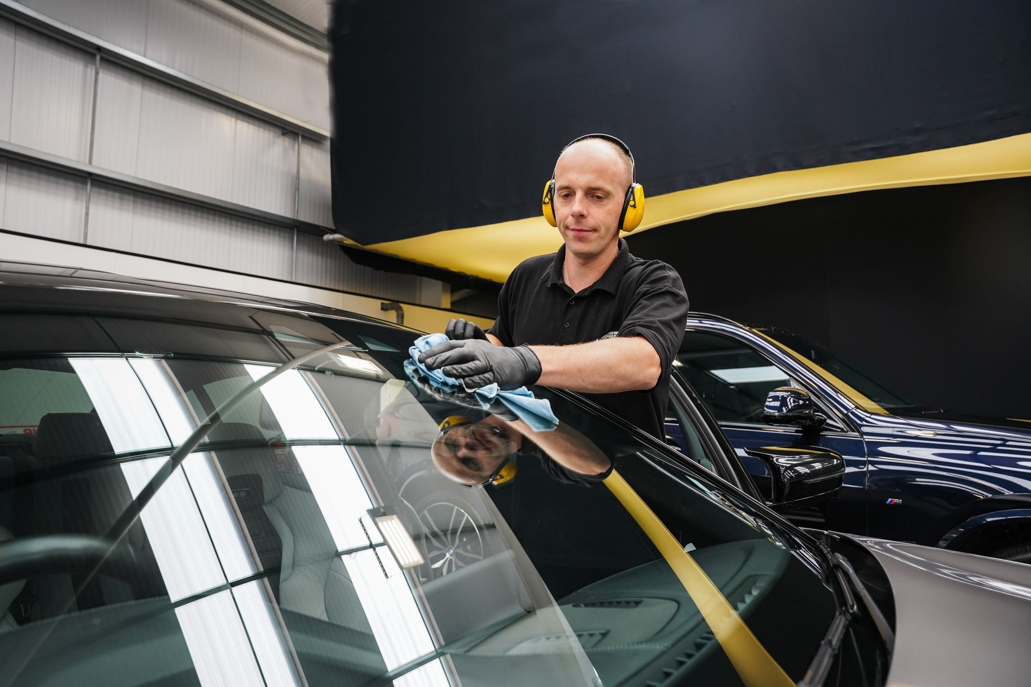 Repair Specialist at Agnew Repair Centre uses LifeShine Glass Protection on front windscreen of vehicle