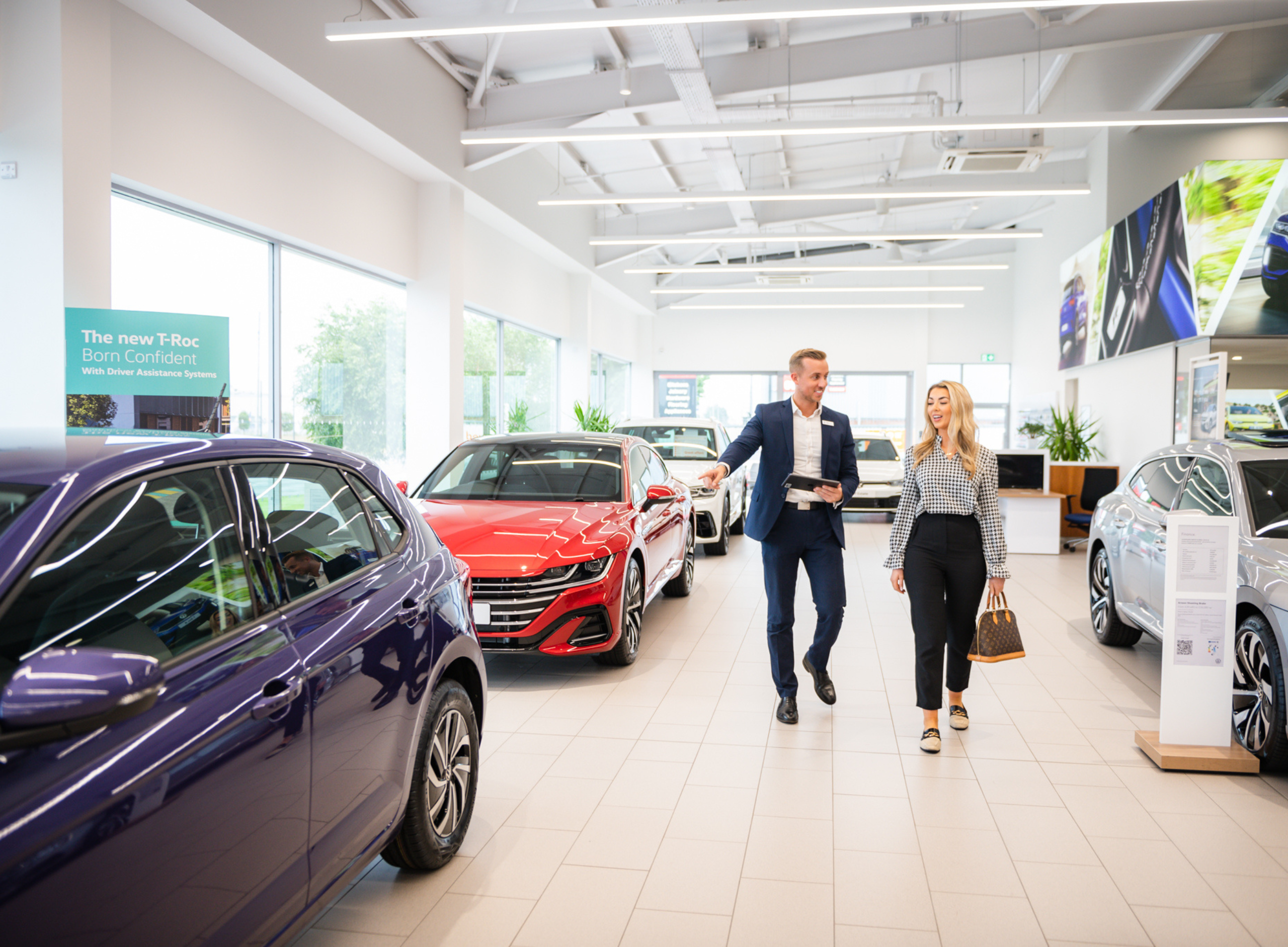 Agnew Volkswagen salesman showing customer the selection of approved used volkswagen cars