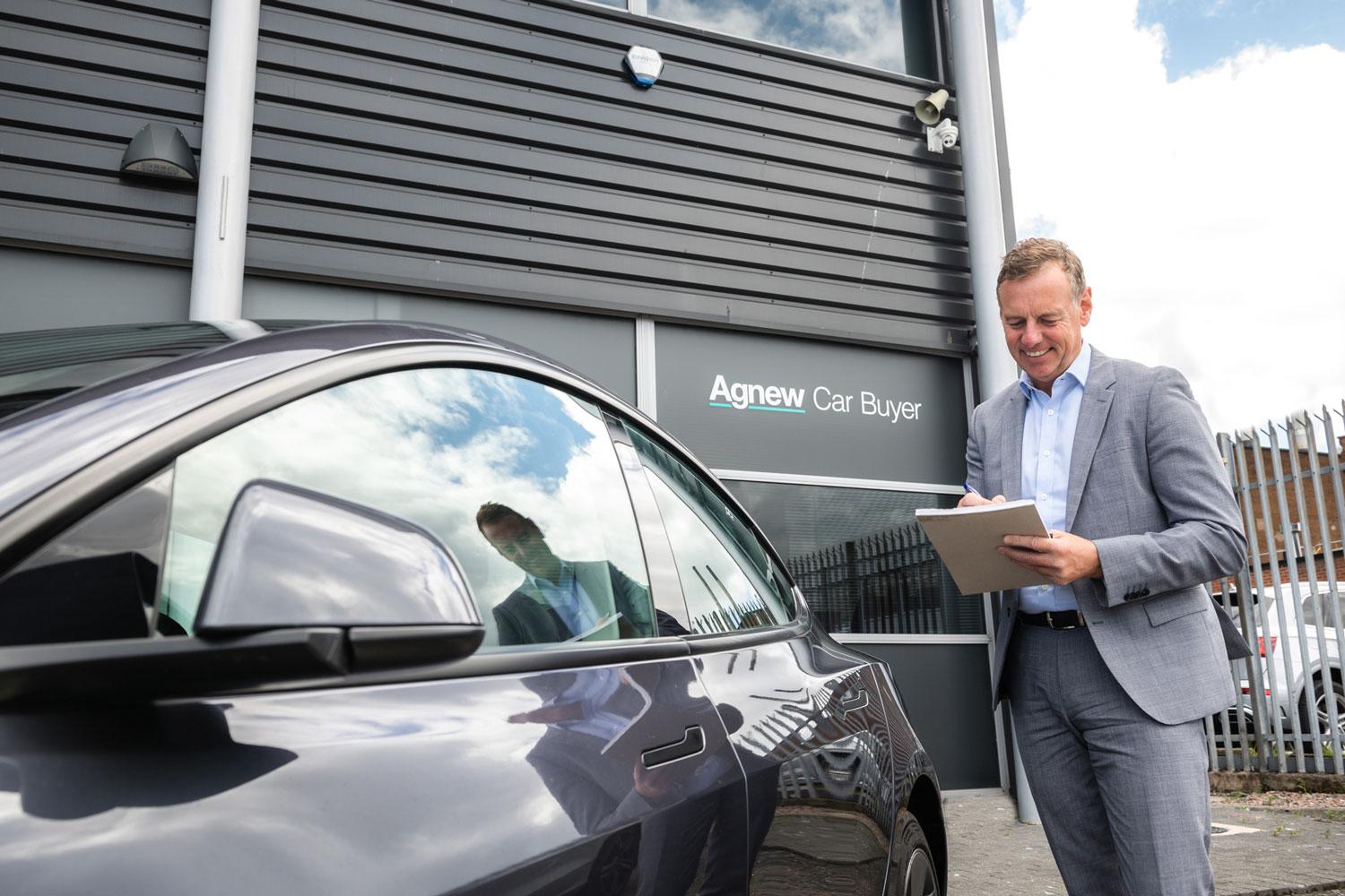 Group Buyer Campbell Stewart checks vehicle for any issues during vehicle eligibility inspection