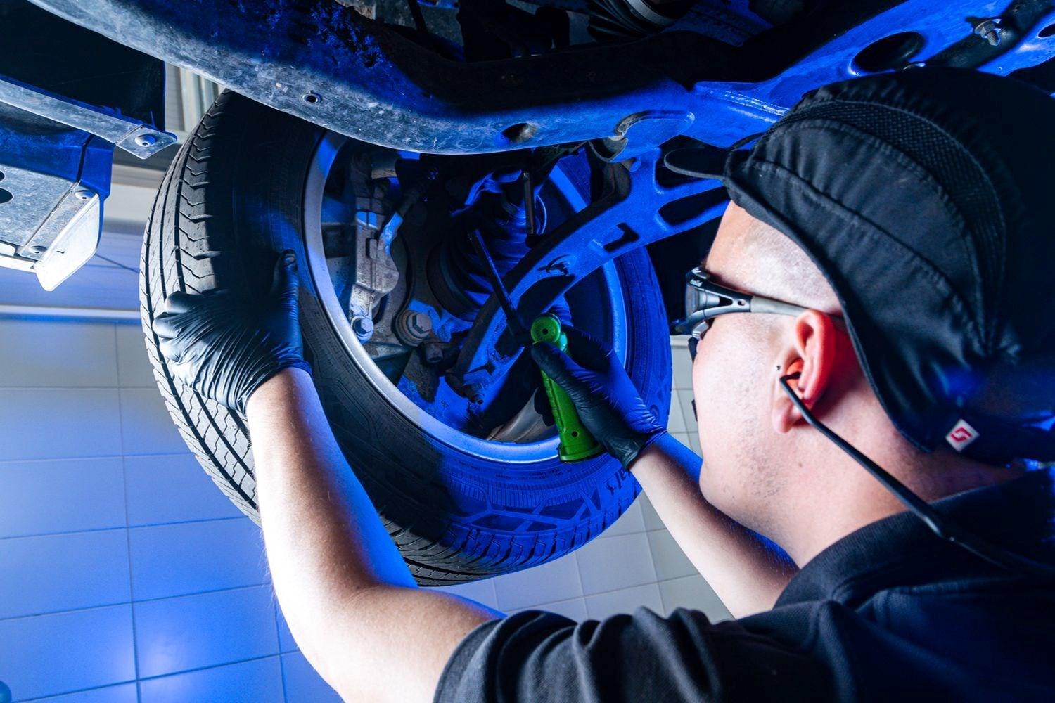 Volkswagen Commercial Vehicle Technician carrying out a wheel inspection.