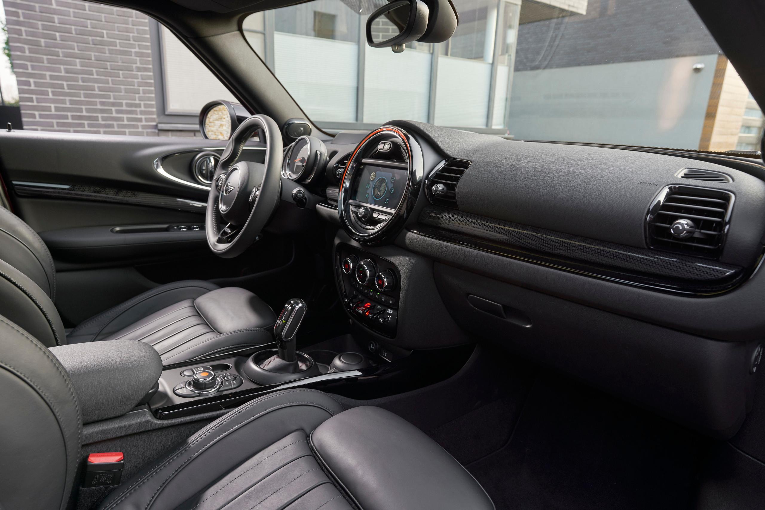 Interior view of the new MINI Clubman, close-up of front passenger seats, steering wheel and central console
