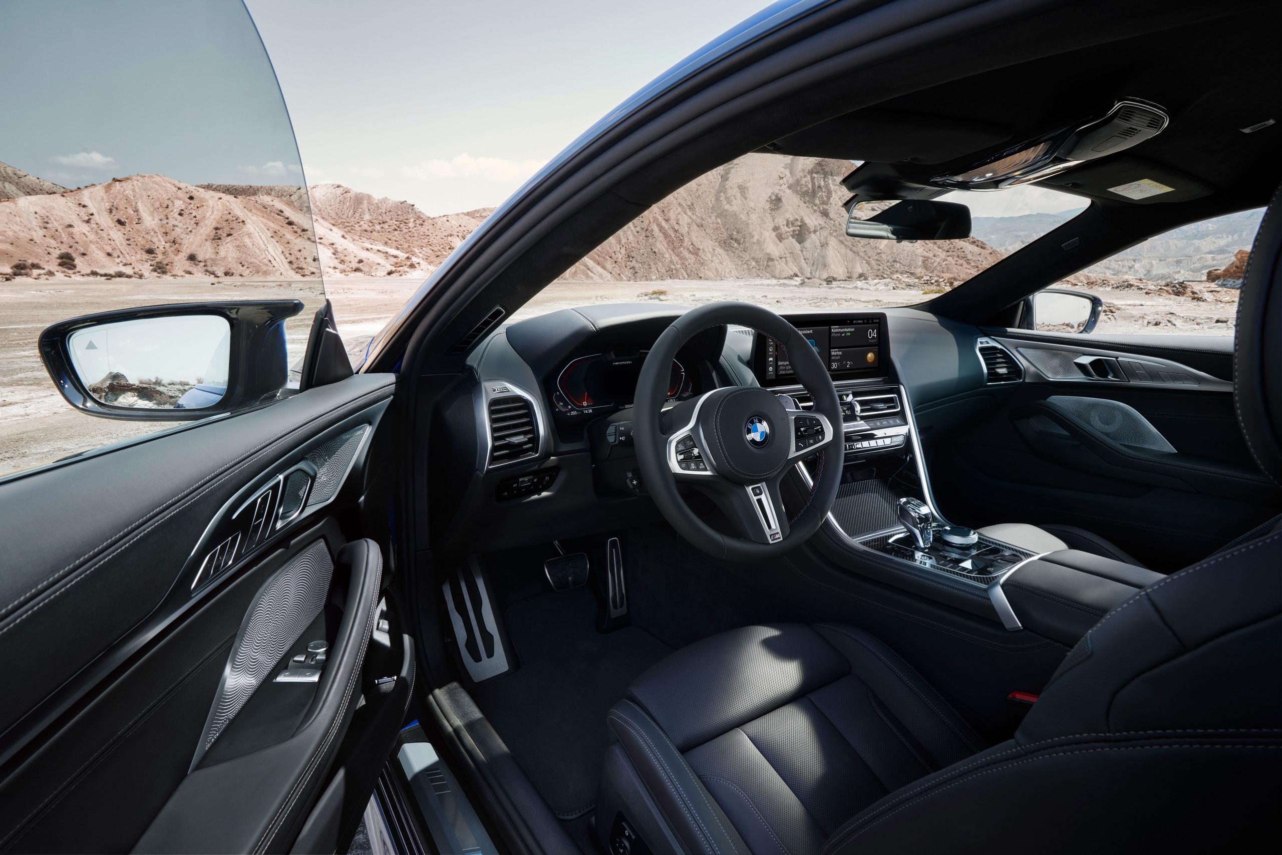 New BMW 8 Series Coupe drivers side driving controls and digital cockpit view