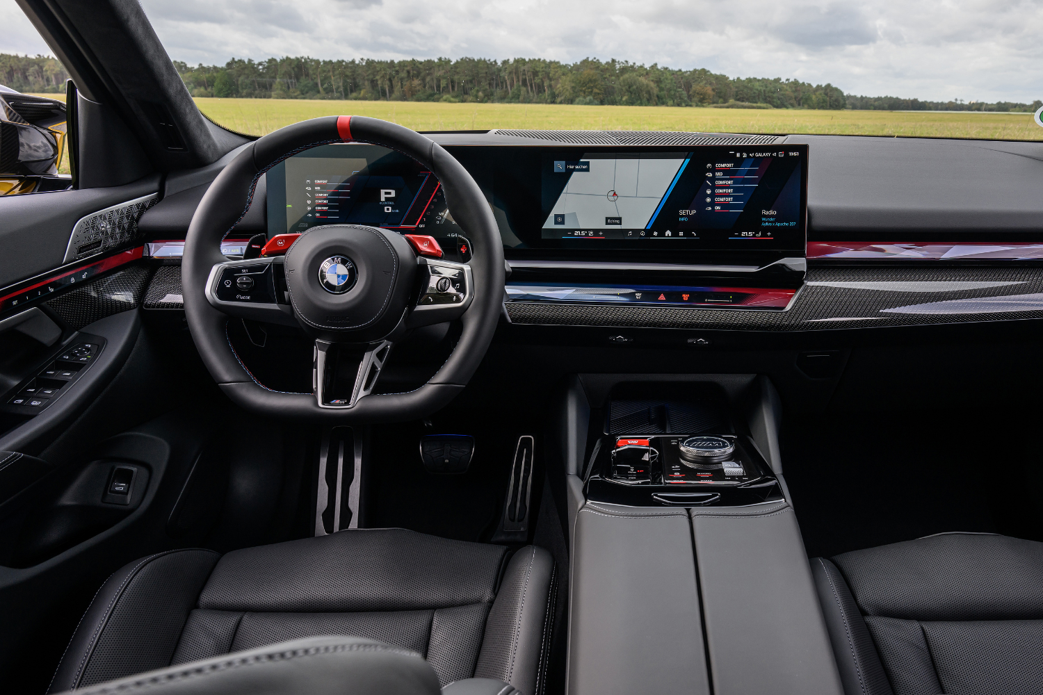Close up of the new BMW M5 Saloon's black, red and blue interior, featuring a dual driver display.