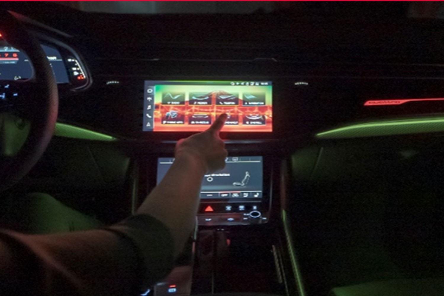 Image of Audi driver using the touch screen infotainment system