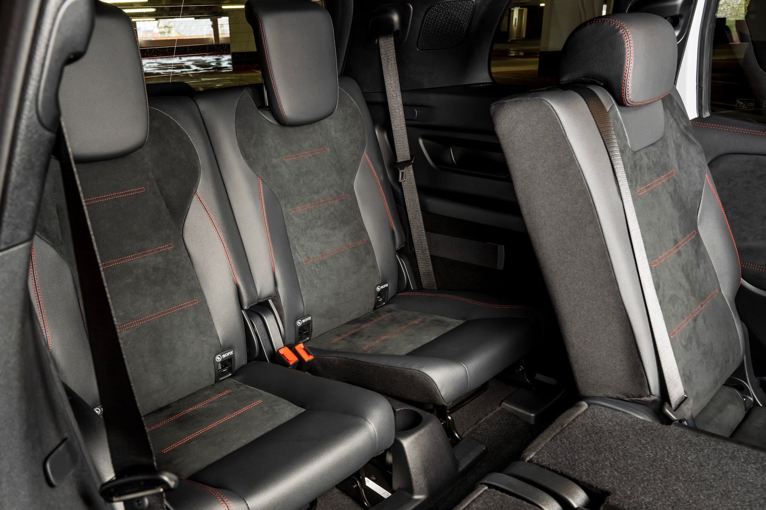 Mercedes-Benz EQB rear passenger dark seats with red stitching.