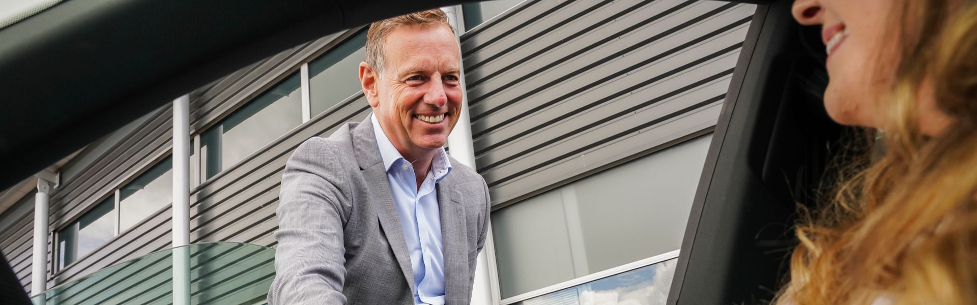 Group Buyer Campbell Stewart shakes hands with customer after agreeing to purchase their vehicle