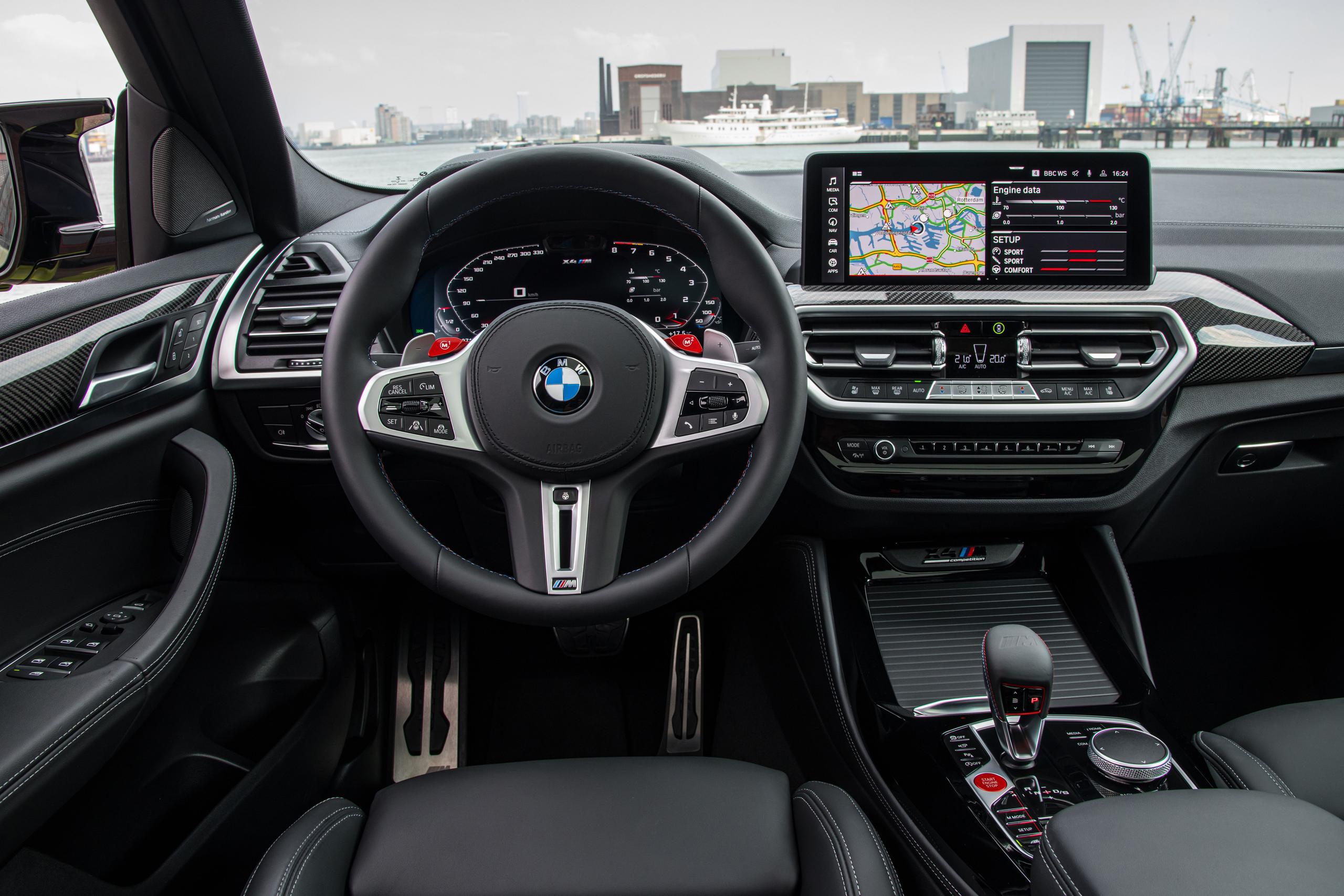New BMW X4 M Competition image of steering wheel and driving controls with infotainment system