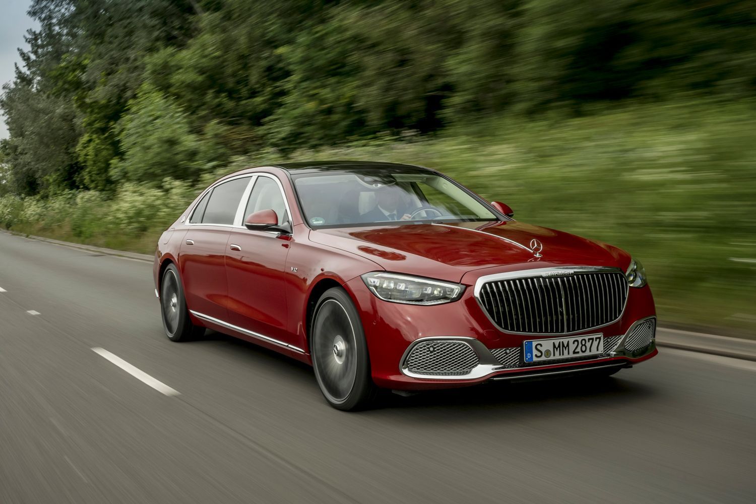 Front view of a red Mercedes-Maybach S-Class driving.