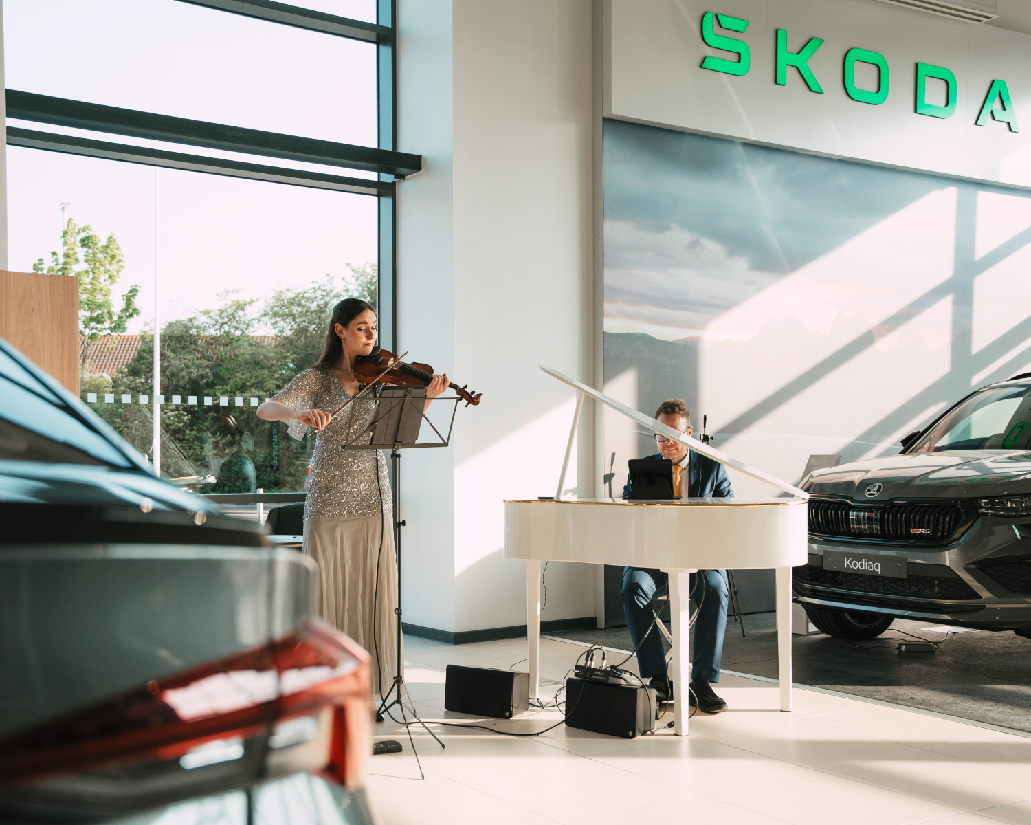 violinist and pianist performing in the new Richmond Skoda Portsmouth car showroom