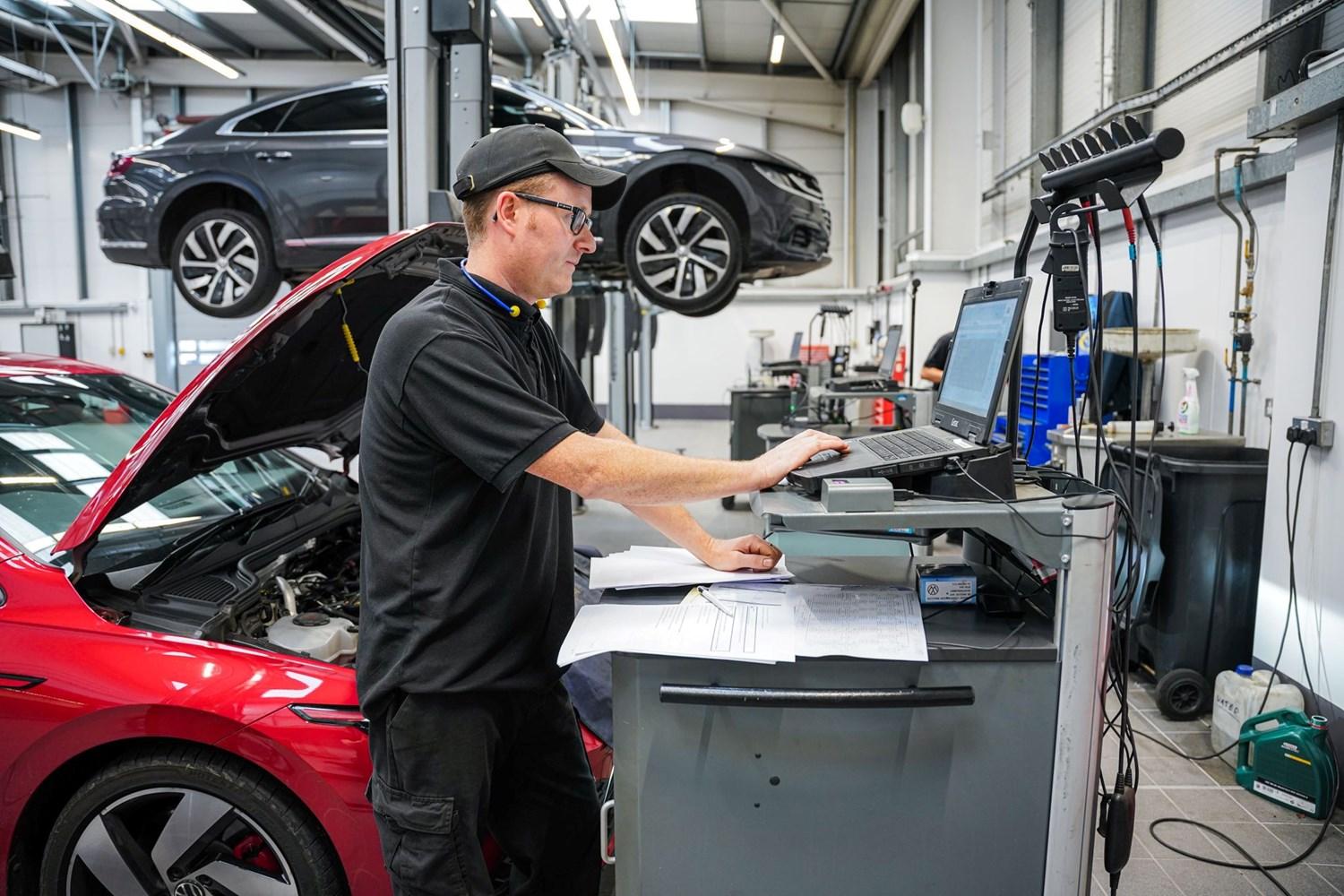 Volkswagen Service Specialist adds notes about Volkswagen ID.3 during service inspection at the Volkswagen Approved Accident Repair Centre, Agnew Volkswagen Belfast