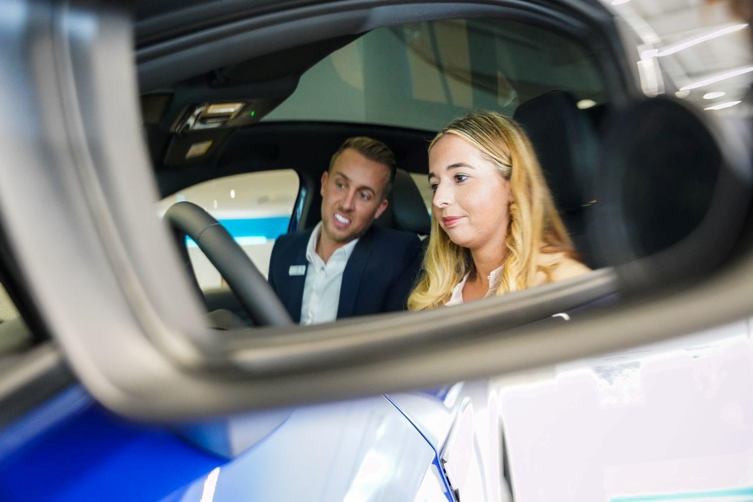 Volkswagen Sales Specialists highlights the key features of inside a Volkswagen ID.4 with a customer at Agnew Volkswagen Belfast