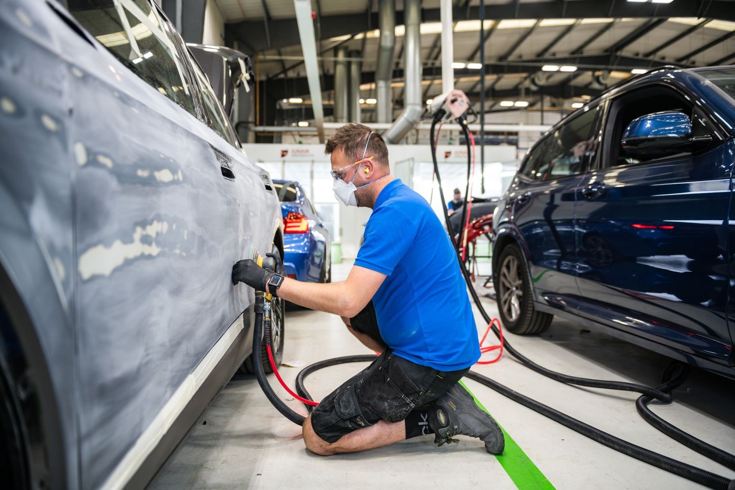 Agnew Repair Centre Specialist sands down the side of a damaged vehicle for preparation for filler application.