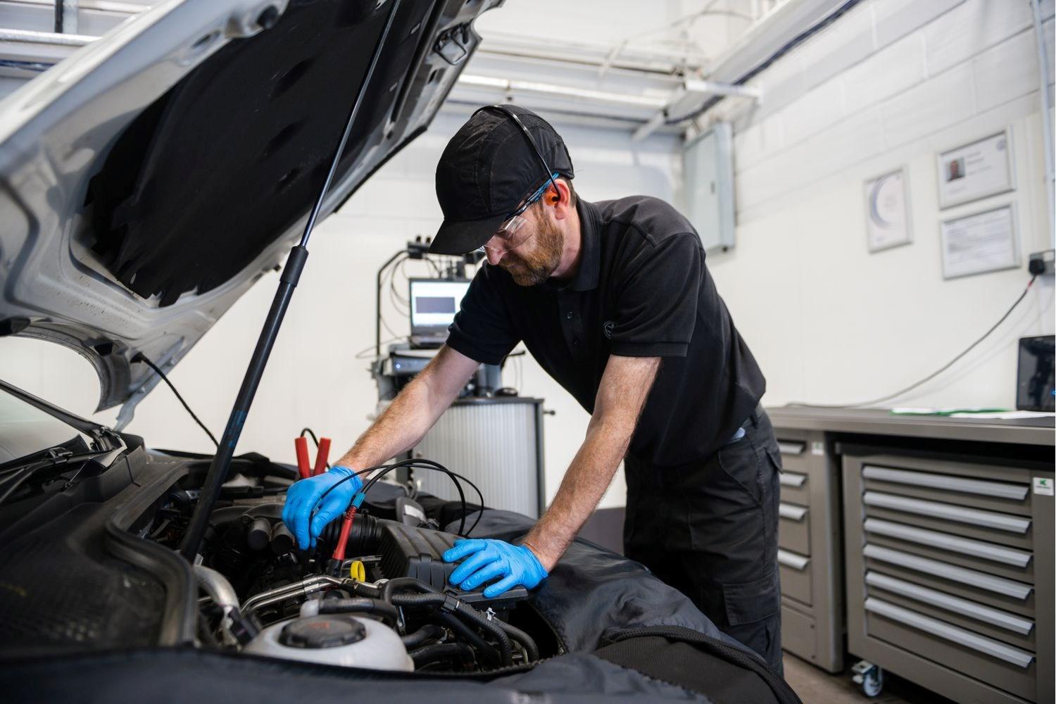 Volkswagen Service Specialist tests battery of Volkswagen Golf during repairs at the Volkswagen Approved Accident Repair Centre, Agnew Volkswagen Belfast