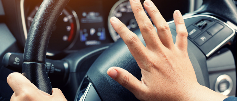 Hand on car horn
