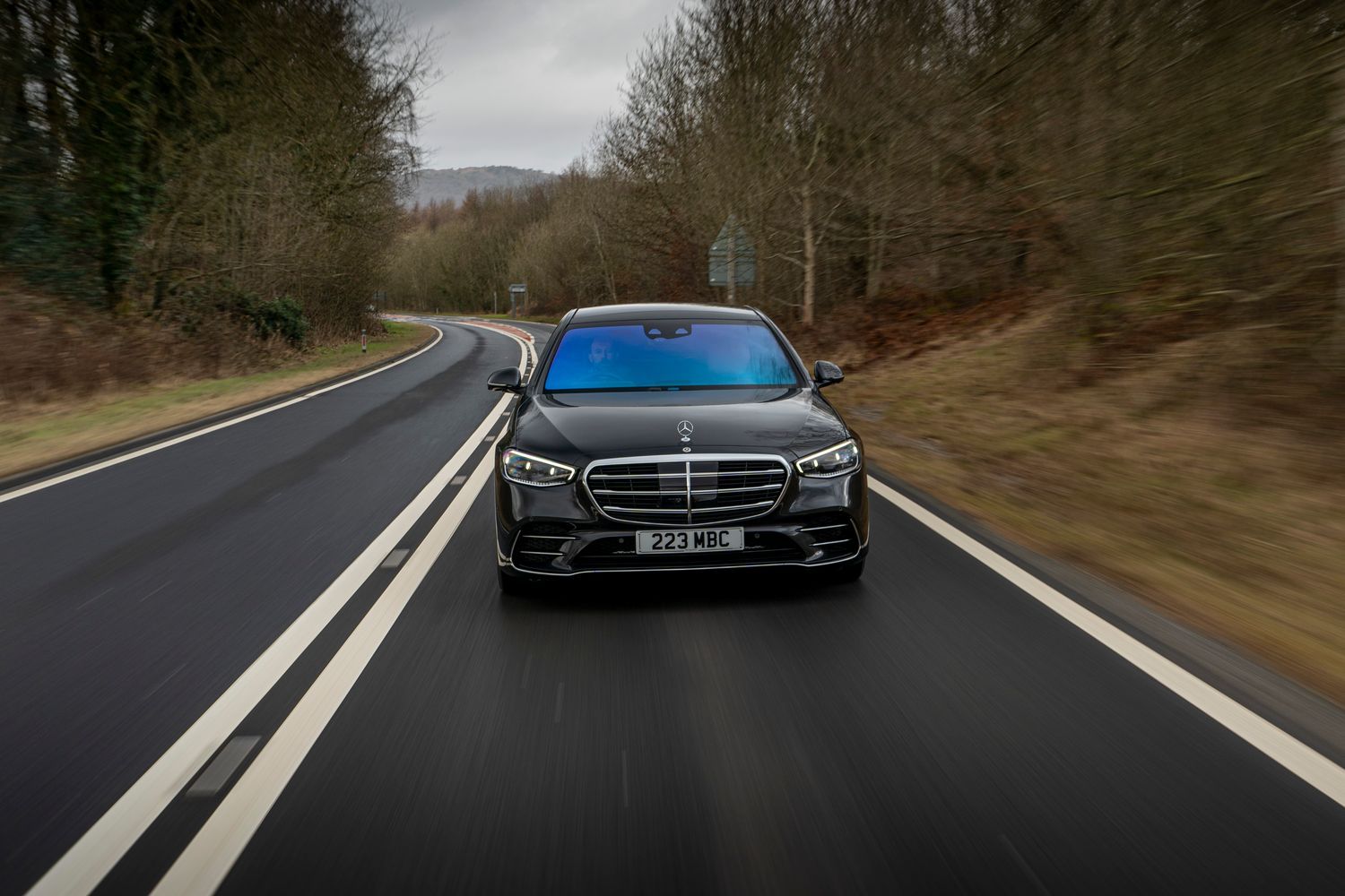 A front view of a black Mercedes-Benz S-Class Saloon driving.