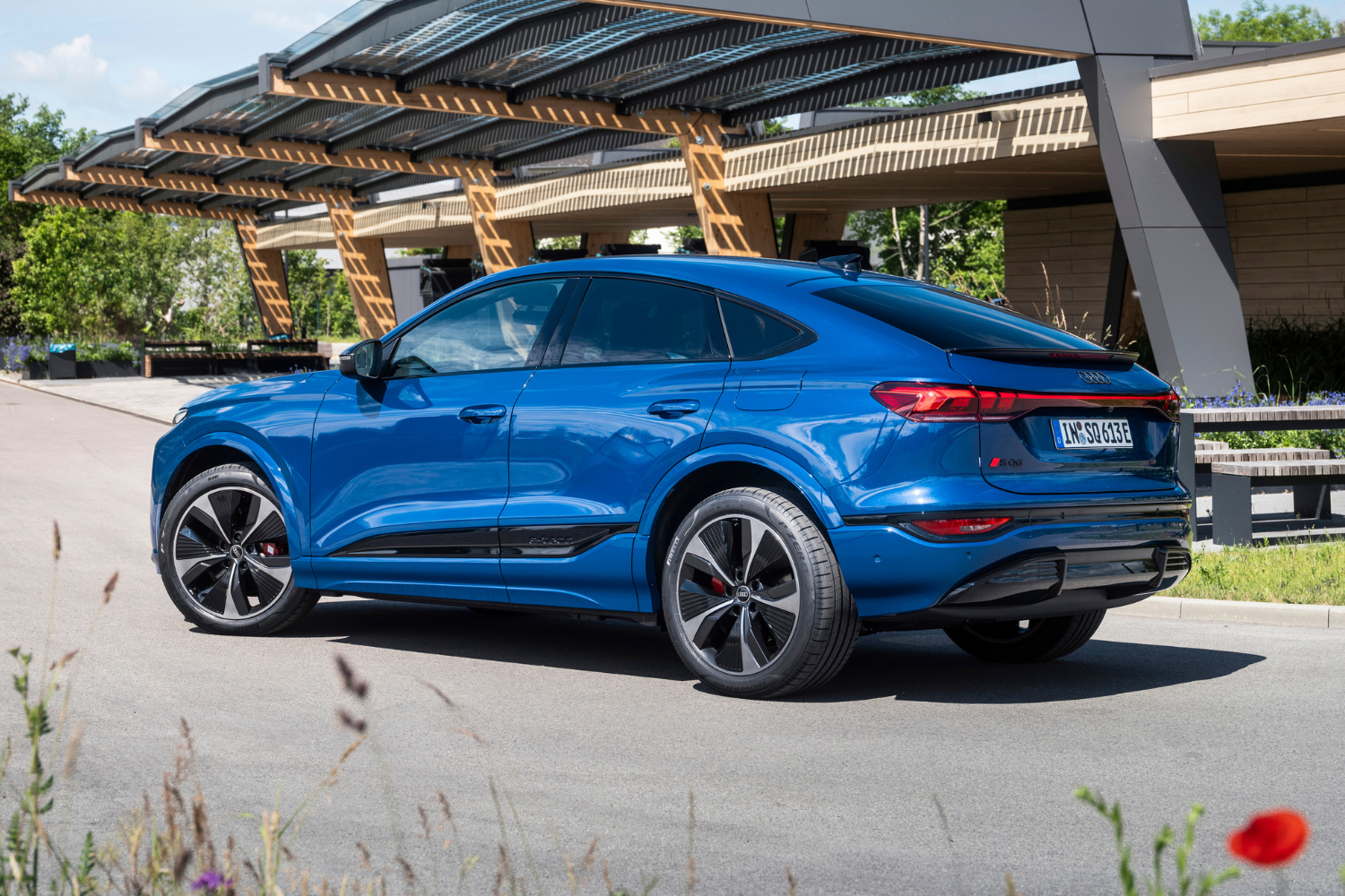 Side profile of the Audi SQ6 Sportback e-tron in Ascari blue metallic.