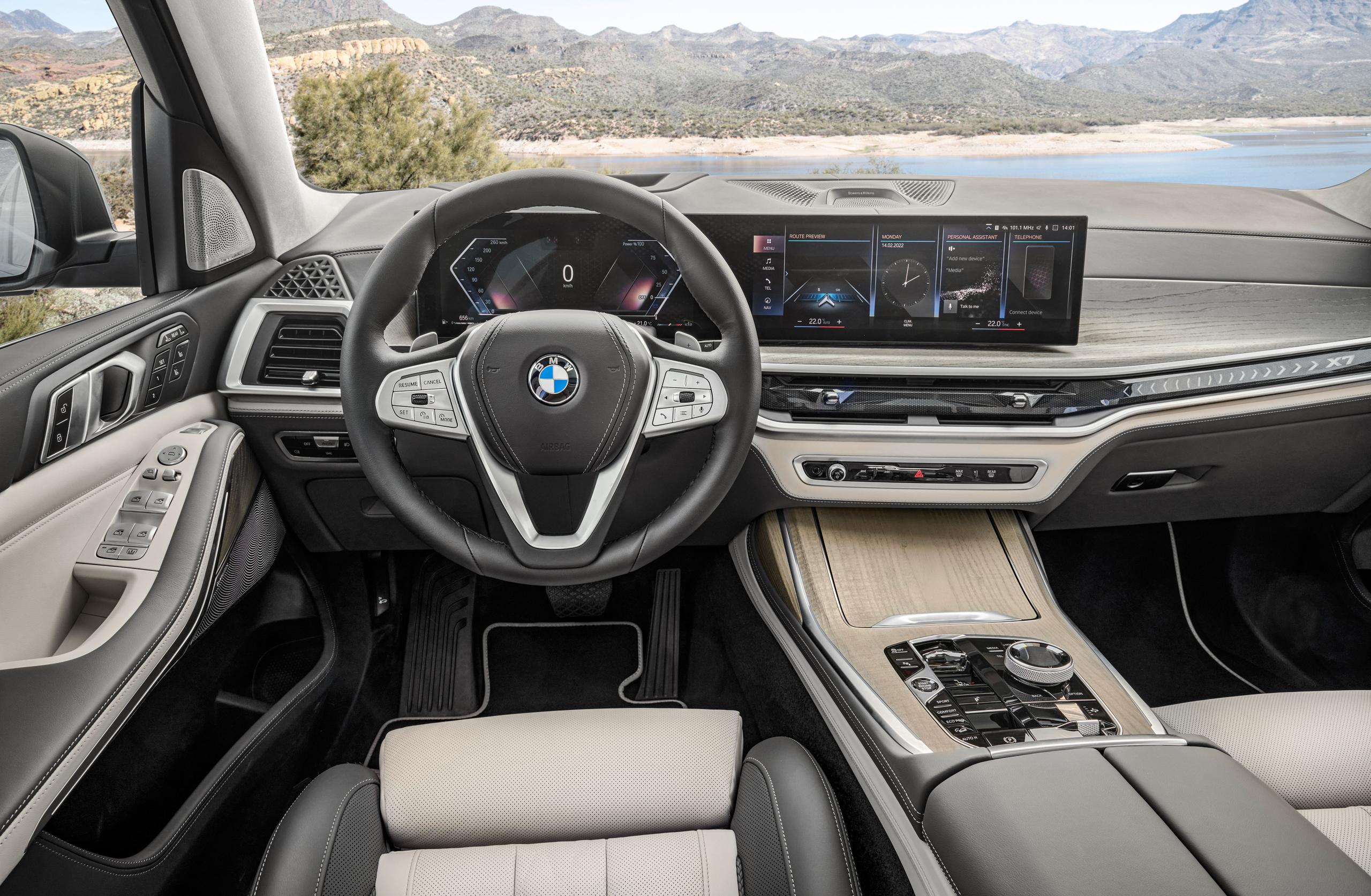 Interior view of the BMW X7, close-up on steering wheel and central infotainment system